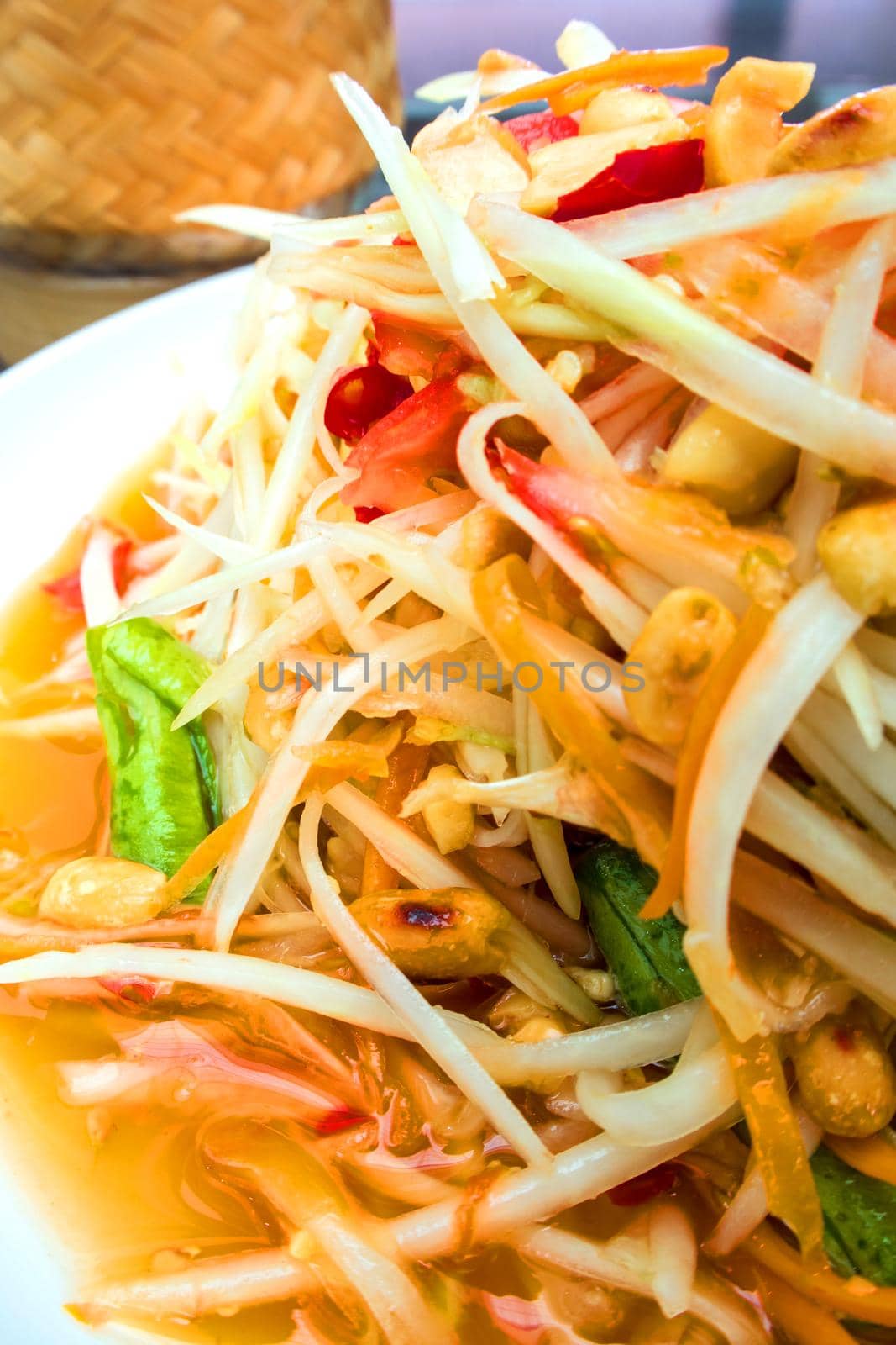 Spicy Thai Papaya Salad in the white plate