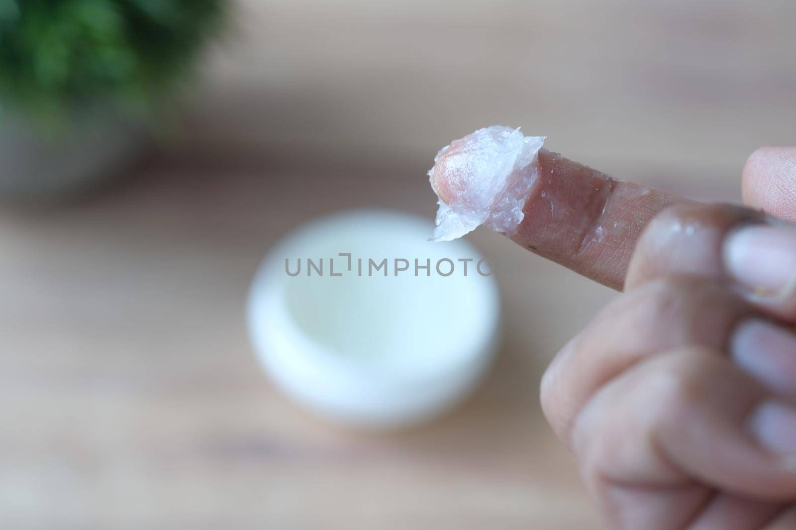 Close up of man hand using petroleum jelly .
