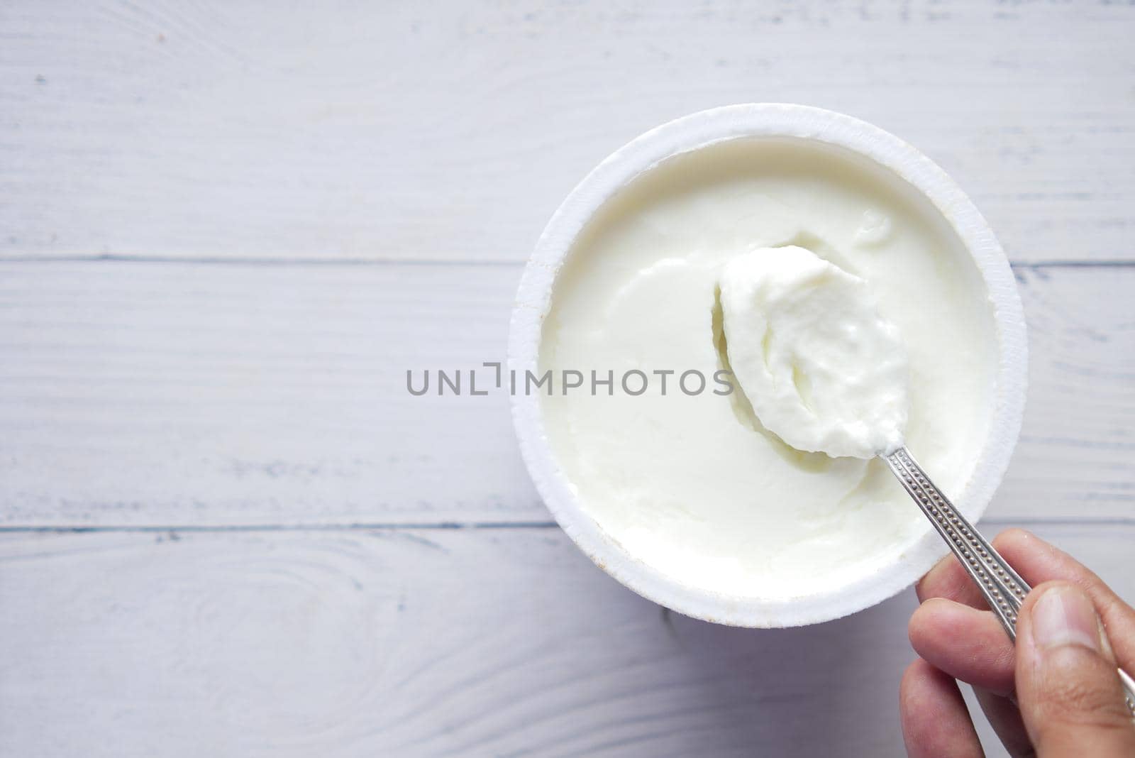 fresh yogurt in a bowl on table .