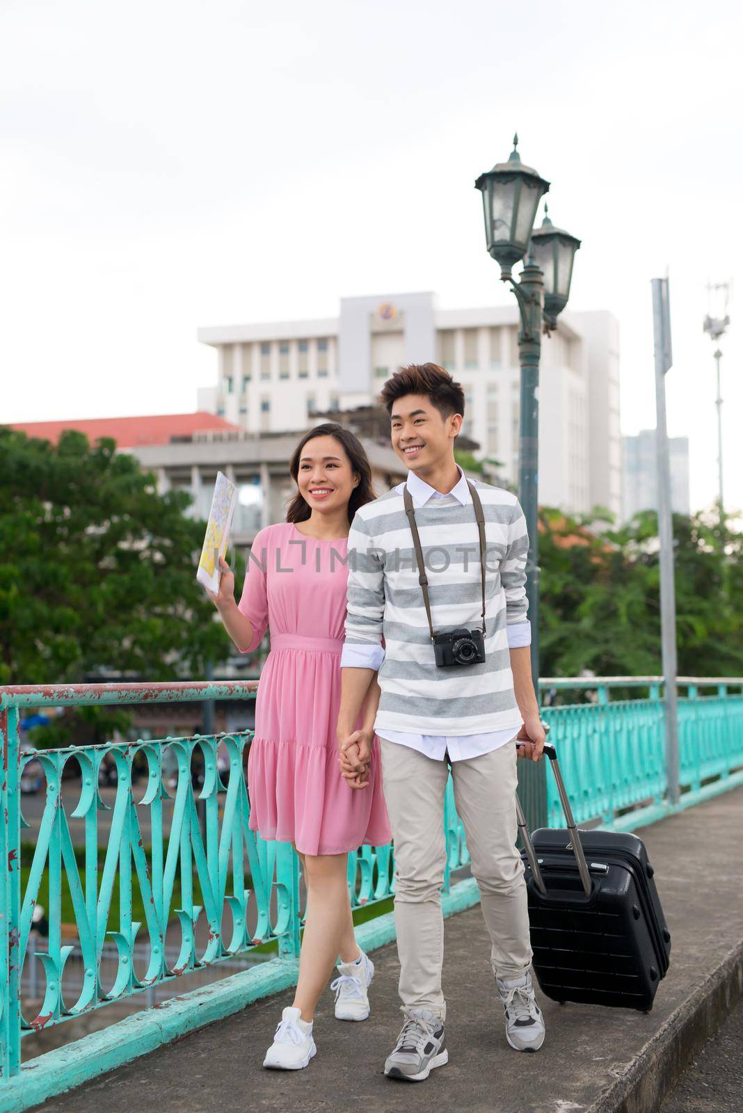 Young happy Asian couple tourist enjoy on summer holiday traveling in Saigon, Vietnam