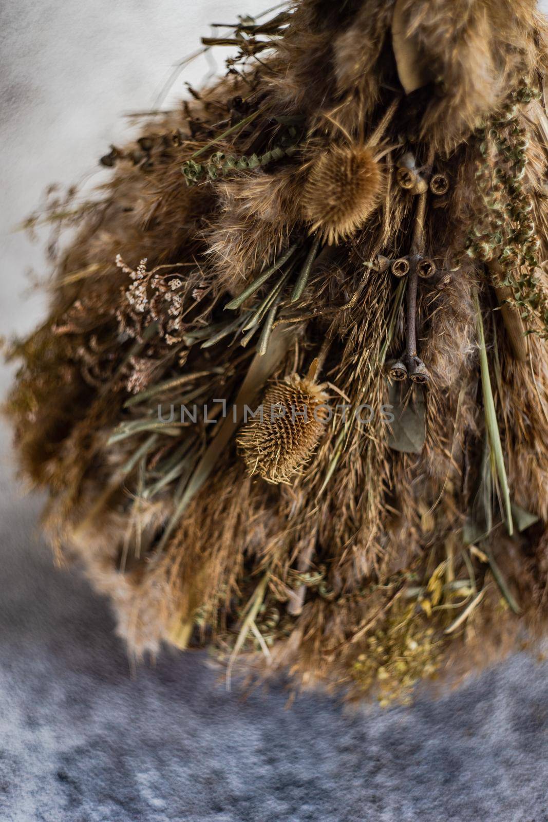 Christmas interior decoration with xmas tree made with dry grass, branches and leaves