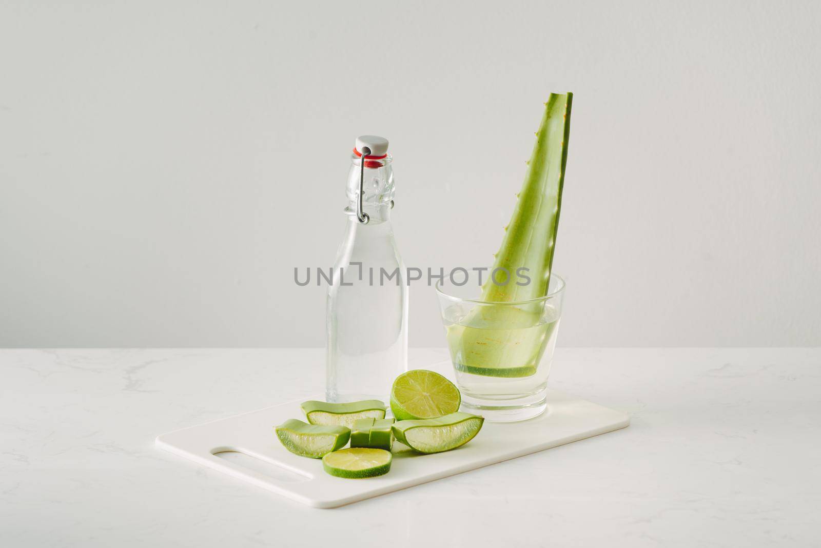 fresh aloe vera leaves and aloe vera juice in bottle glass on white background by makidotvn