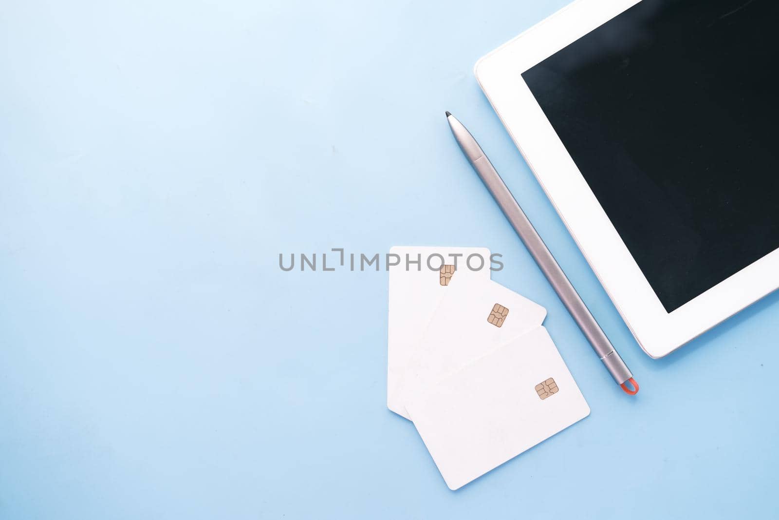 credit cards and digital tablet on blue background ,