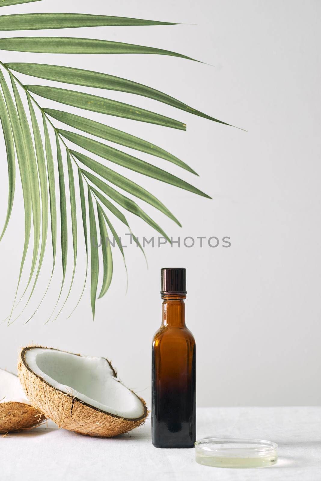 Spa cosmetics in brown glass bottles on gray concrete table. Copy space. Beauty blogger, salon therapy, minimalism concept by makidotvn