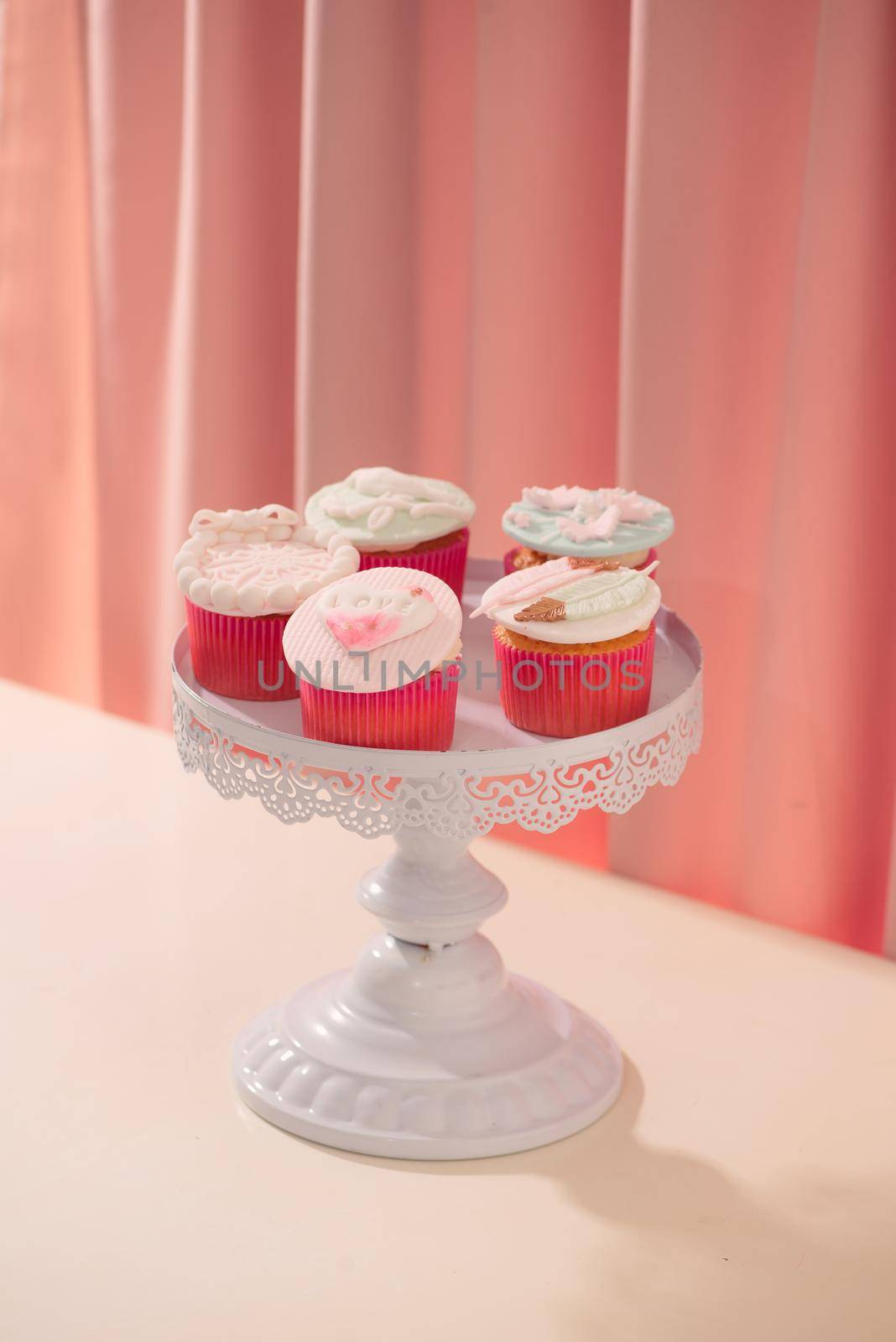 Many yummy cupcakes. Valentine sweet love cupcake on table on light background by makidotvn