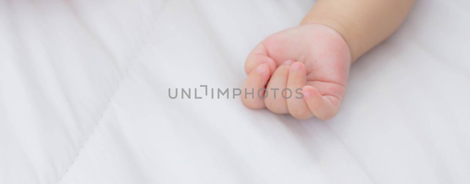 Portrait of asian little baby girl sleeping on bed in the bedroom at home, newborn napping with cozy and relax, infant innocence in bedtime, happy toddler cute, growth of child and emotion, indoors.