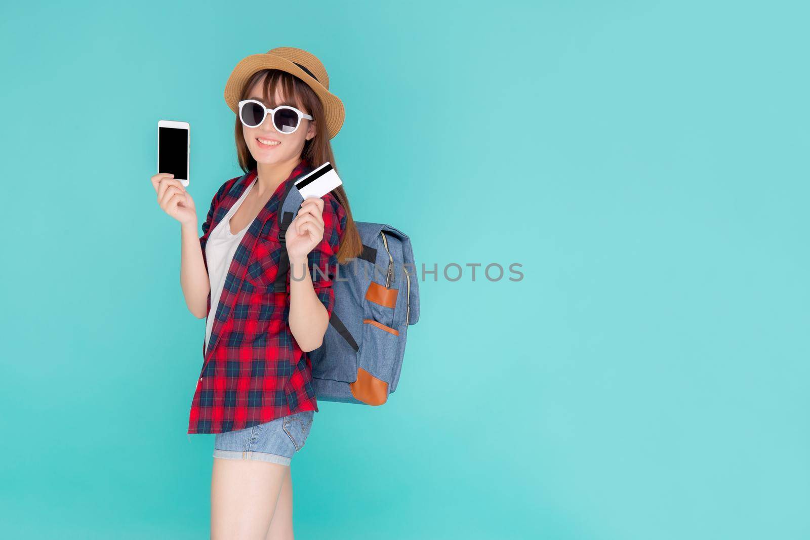 Beautiful portrait young asian woman wear travel summer fashion holding credit card and smart mobile phone in summer, asia girl payment for booking internet online with app in vacation. by nnudoo