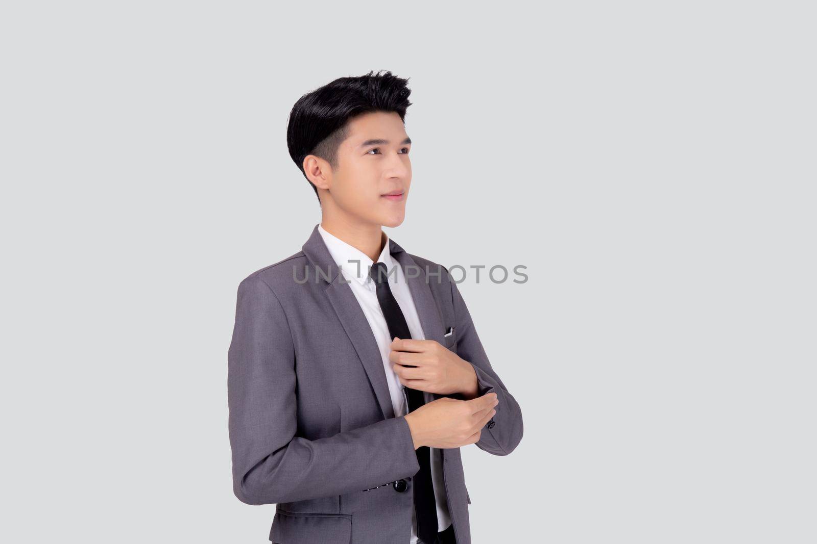 Portrait young asian businessman in suit smiling with confident and friendly isolated on white background, business man smart with success, manager or executive with handsome and leadership. by nnudoo