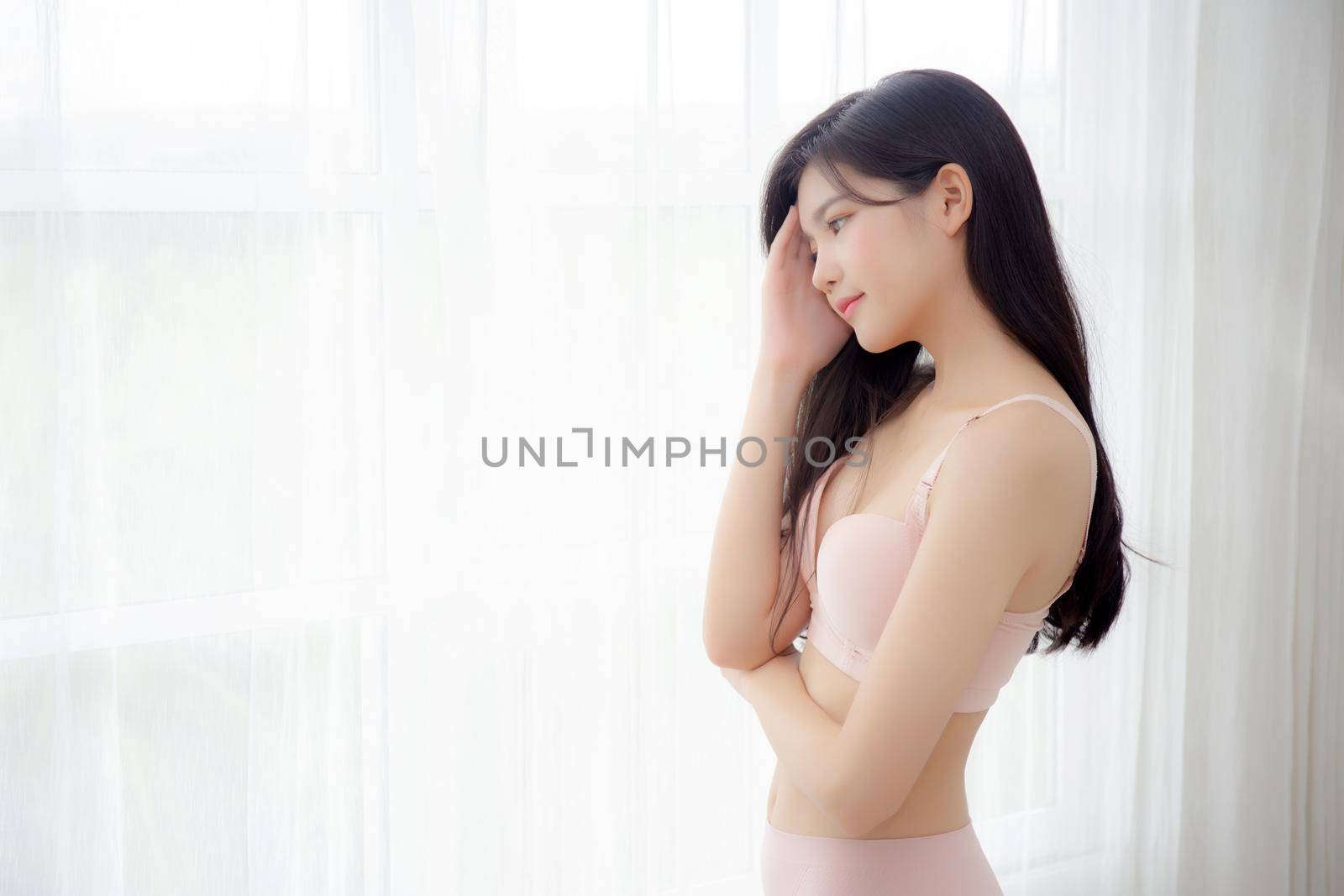 Beautiful portrait young asian woman sexy thinking idea weight loss near the windows for healthy, body of asia girl happy with diet and cheerful with wellbeing, lifestyle and relax concept.