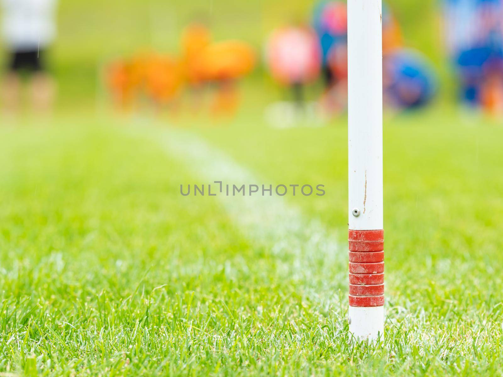 Corner kick spot on artificial grass football stadium, players in blue and orange by rdonar2