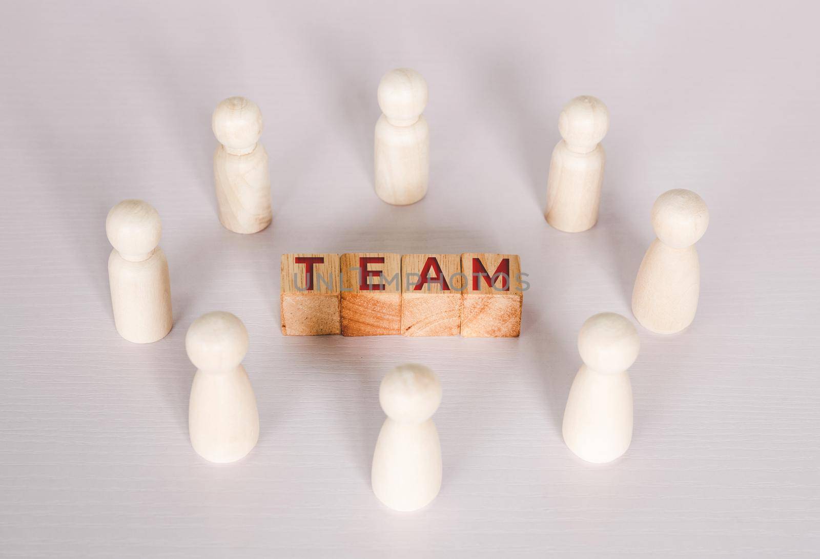 Word team on wooden block, relationship of collaboration and leadership for success, group of community and employee with corporate, teamwork for brainstorming together, no people, business concepts. by nnudoo
