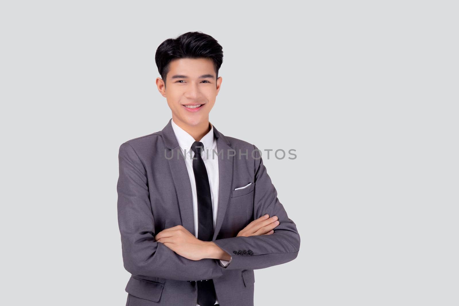 Portrait businessman in suit with crossed his arms standing isolated on white background, young asian business man is manager or executive having confident is positive with success. by nnudoo