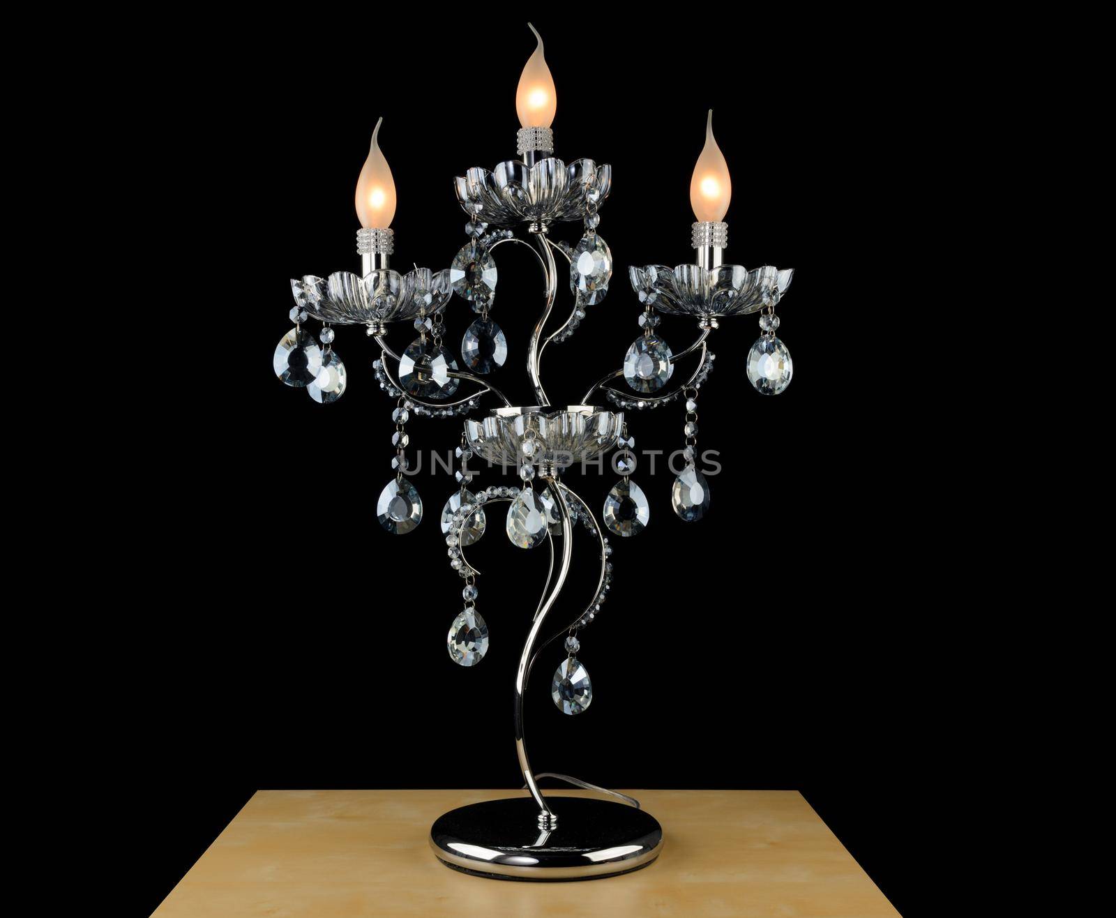 Contemporary glass chandelier isolated over black background