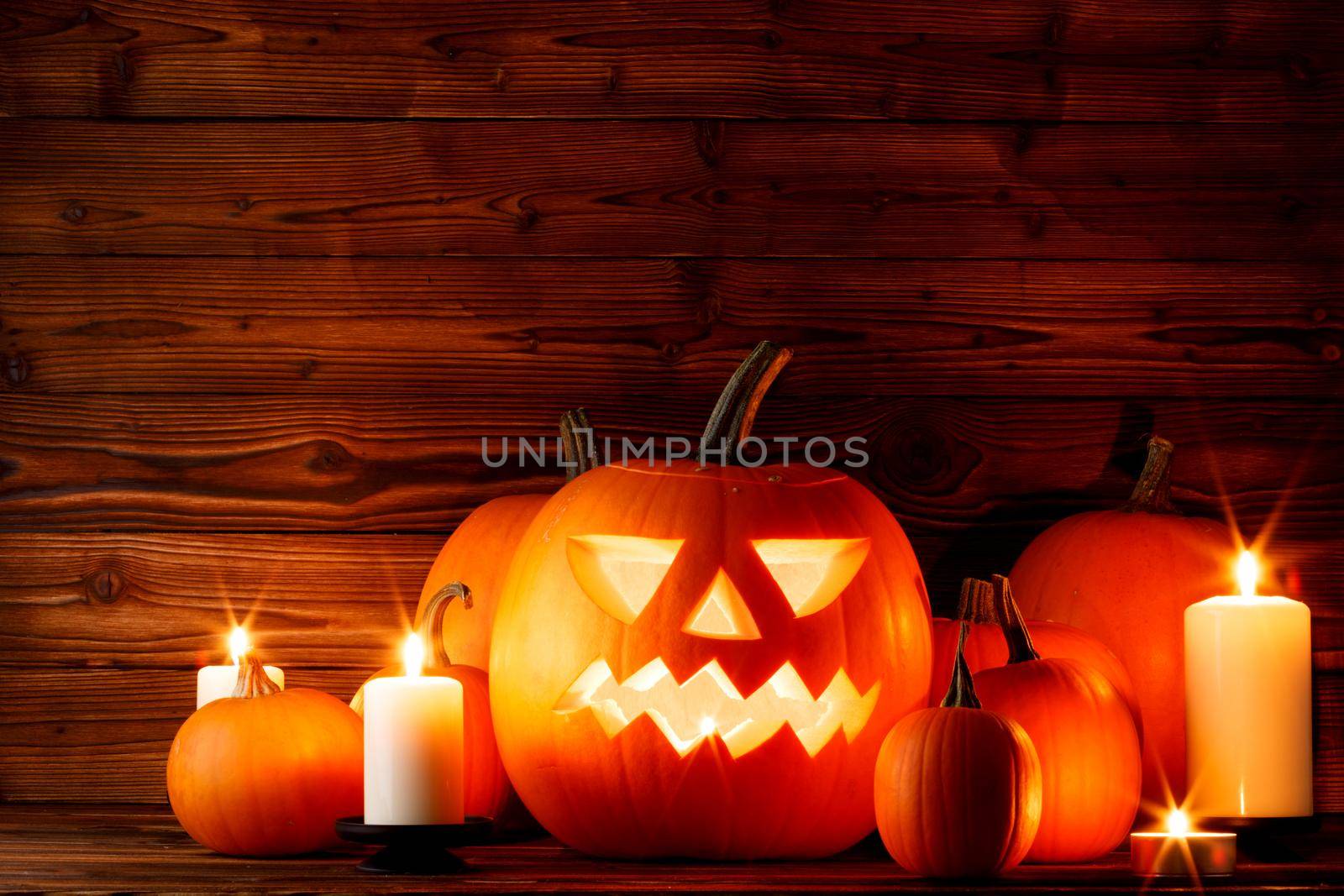 Halloween pumpkins with cut faces and candles dark holiday card