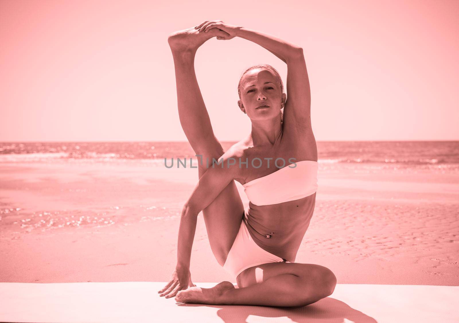 Woman doing yoga asana at the beach