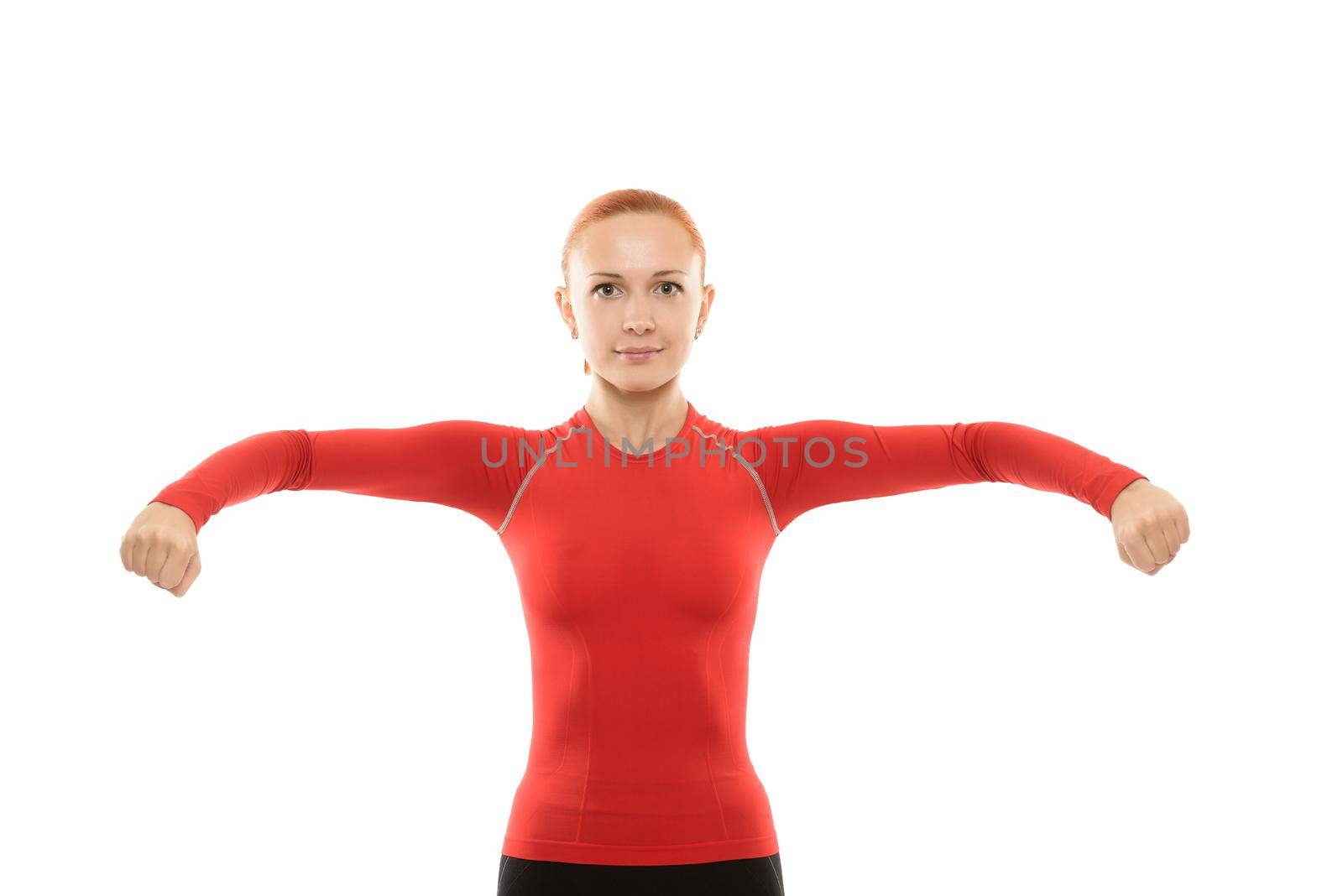 Beautiful young red woman performing fitness exercises over white background