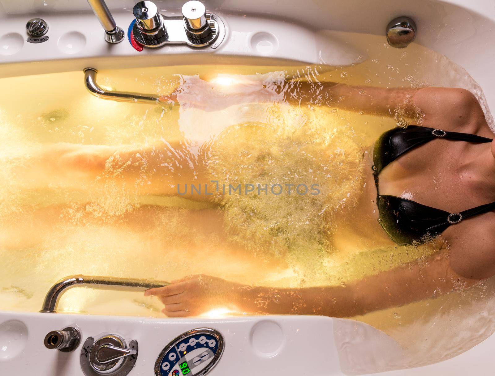 Beautiful woman relaxing in jakuzzi bath