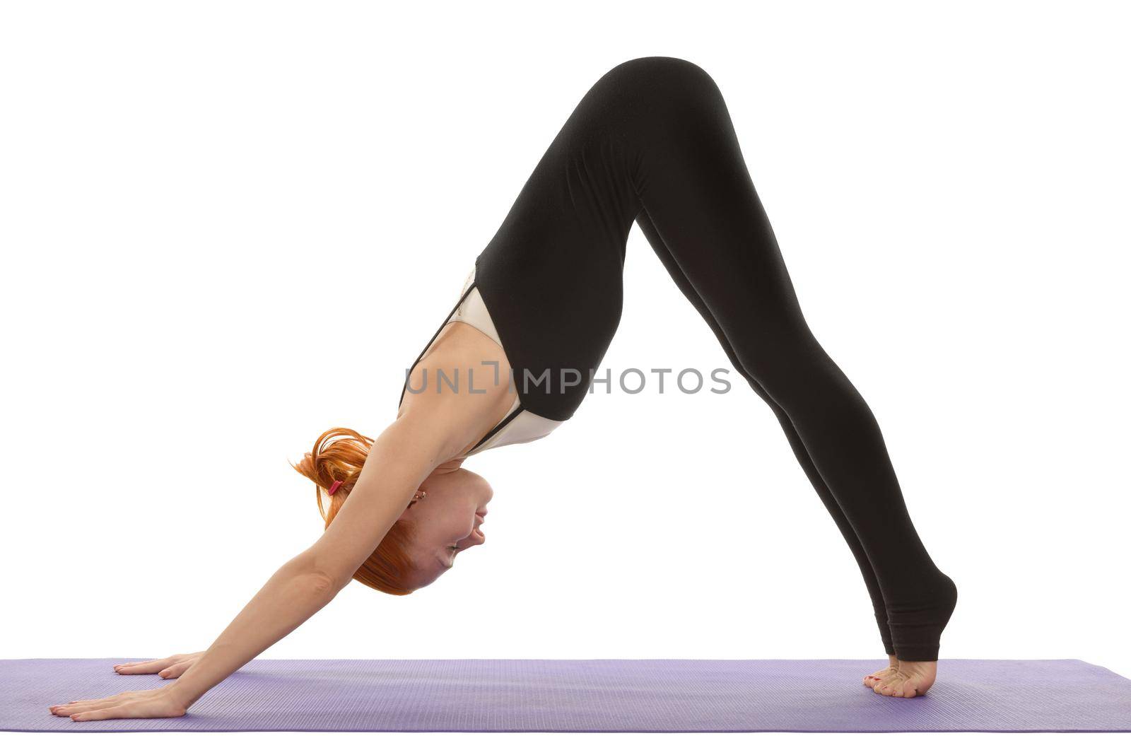 Young woman in downward facing dog yoga asana