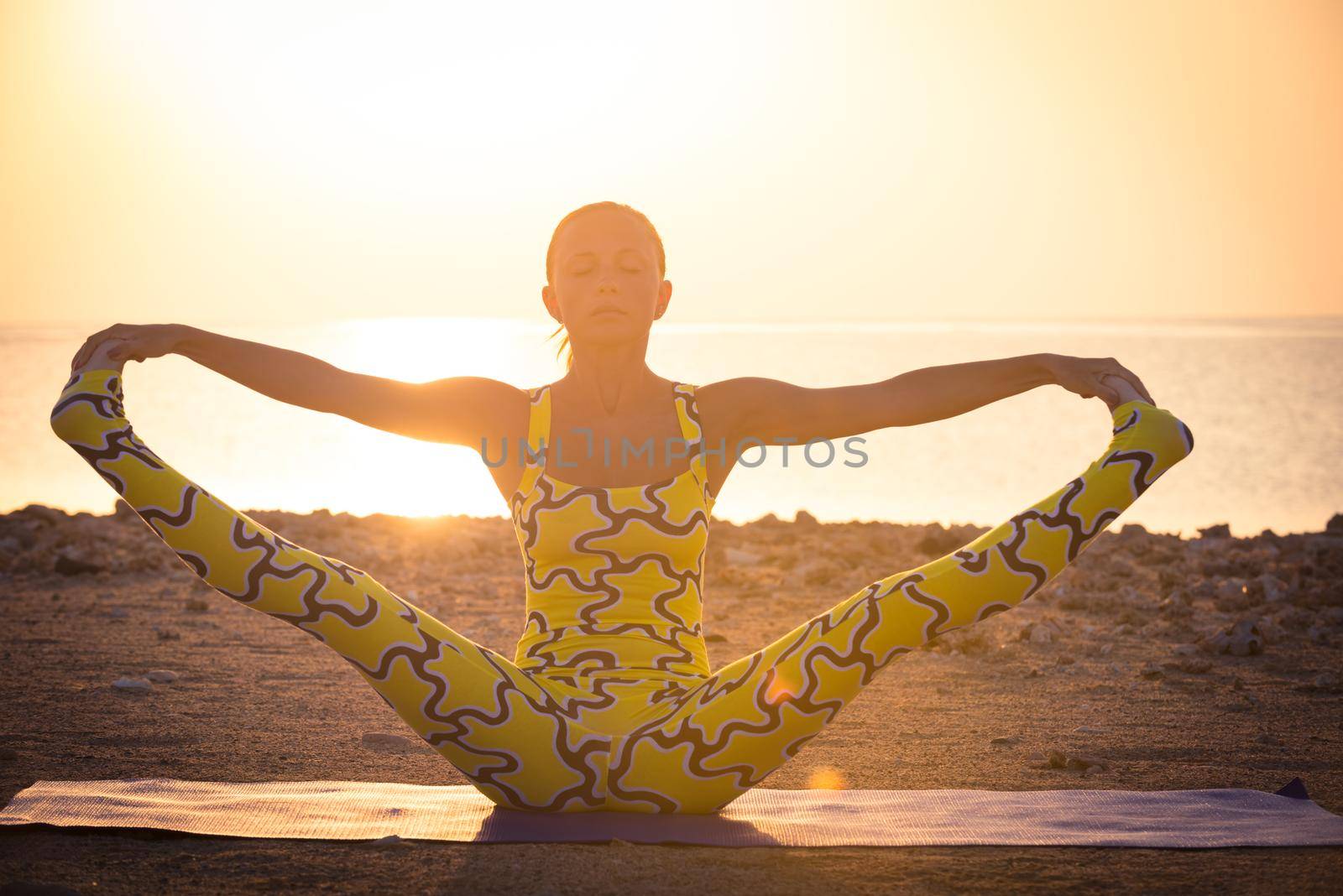 Yoga practice. Woman doing asana at sunrise