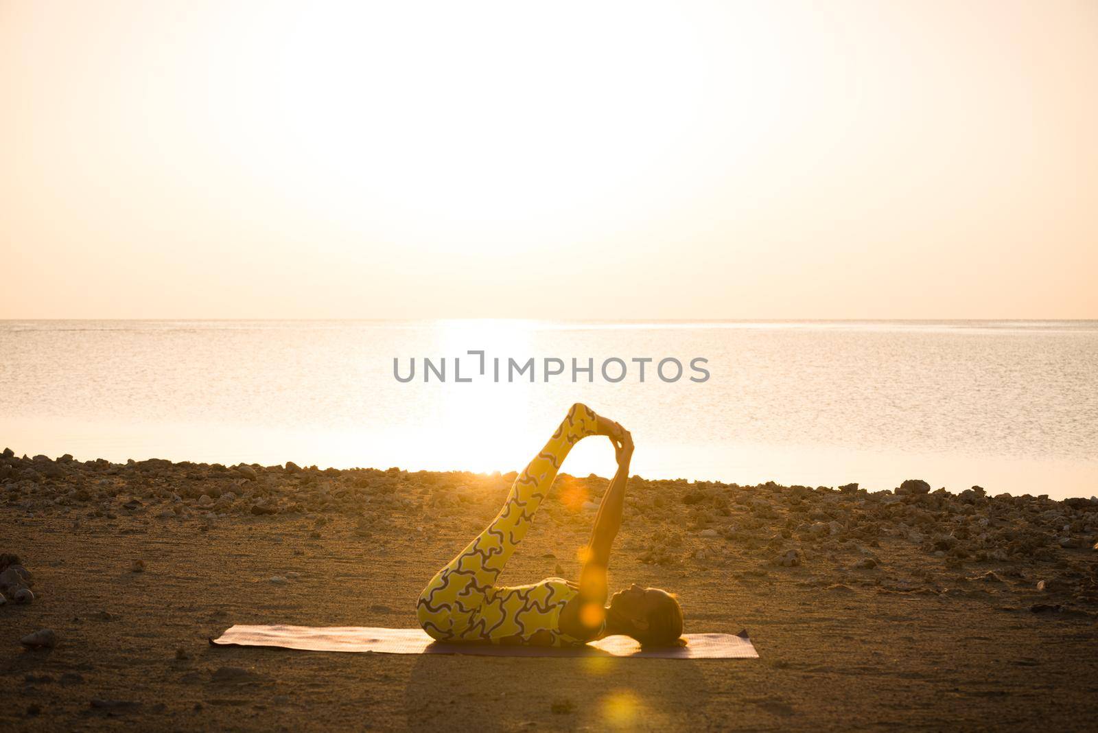 Yoga practice. Woman doing asana at sunrise