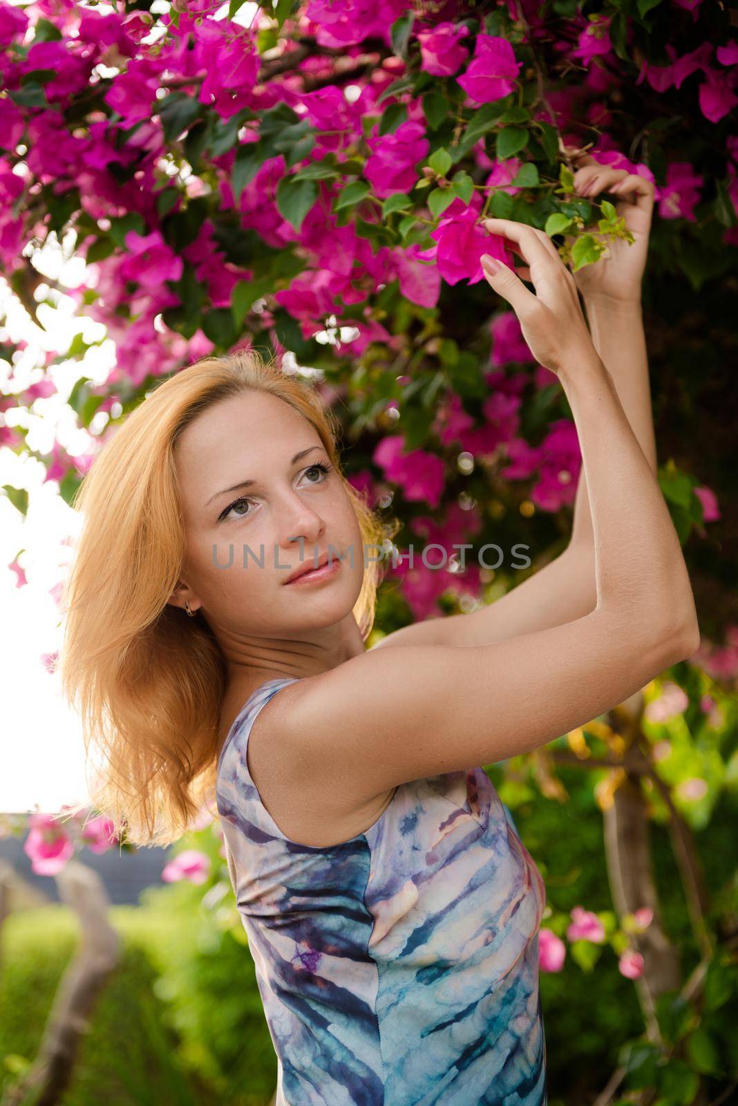 Young red woman wearing long dress with flowers