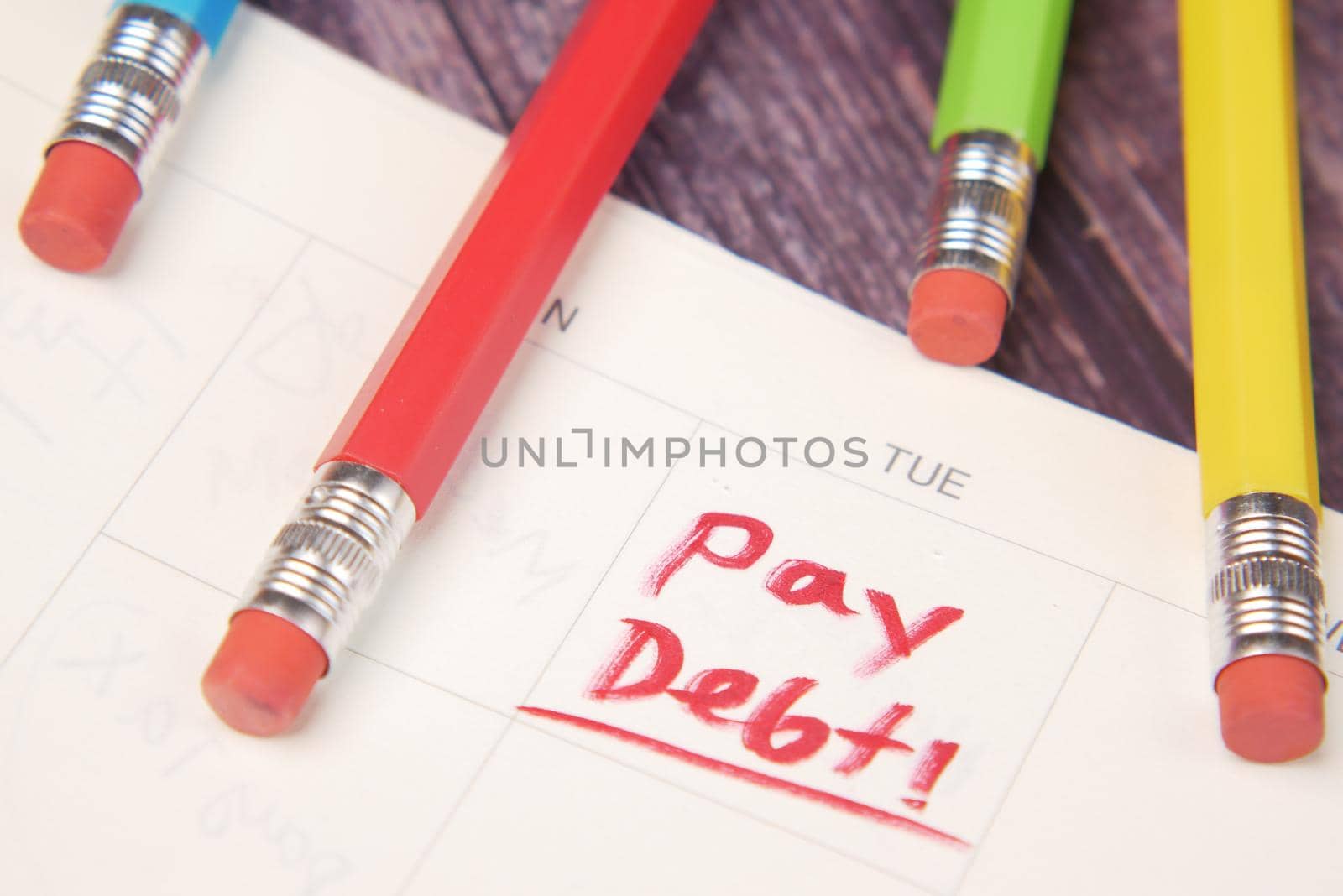 Close up of pay debt word on calendar.