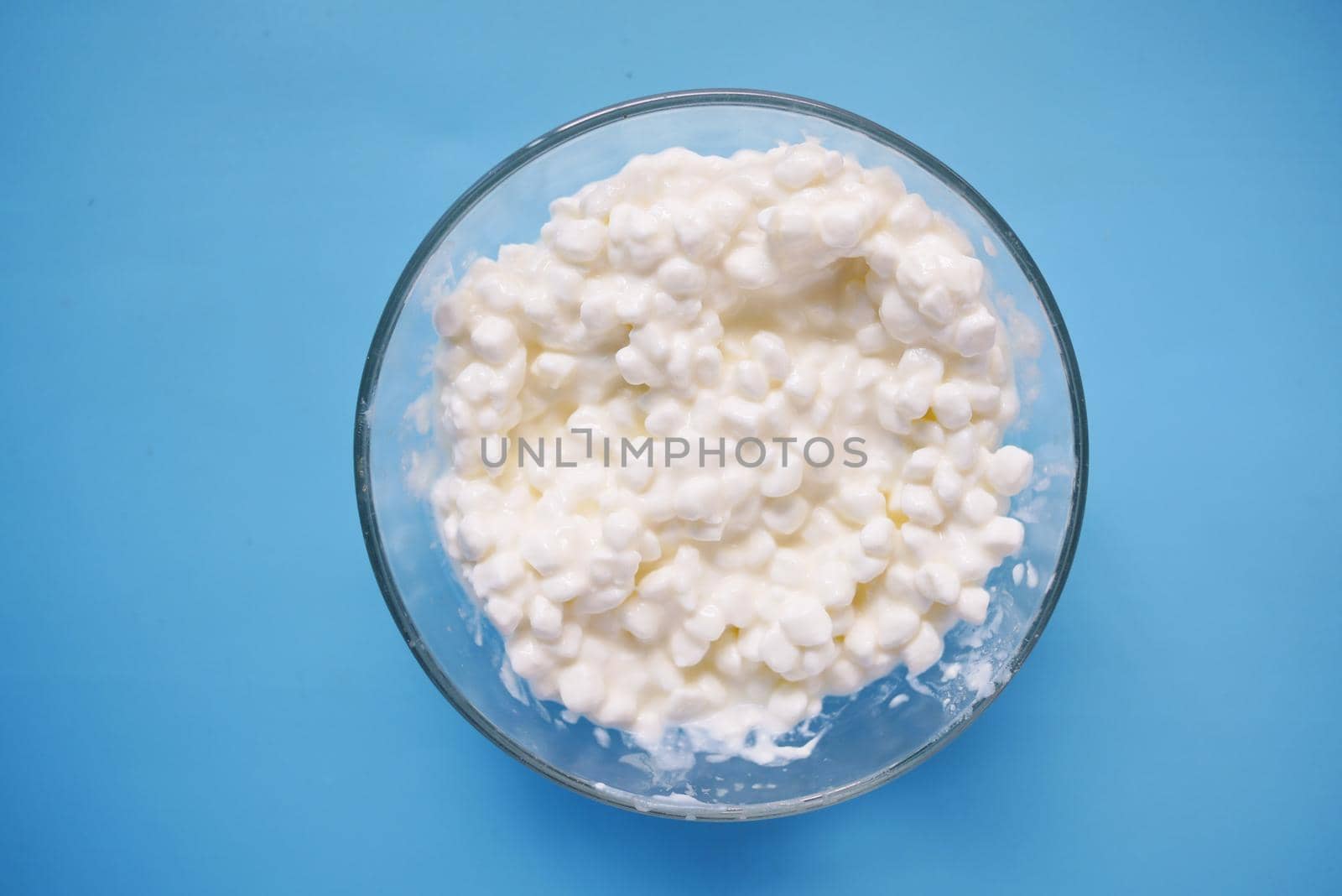 close up of cottage cheese on spoon on table