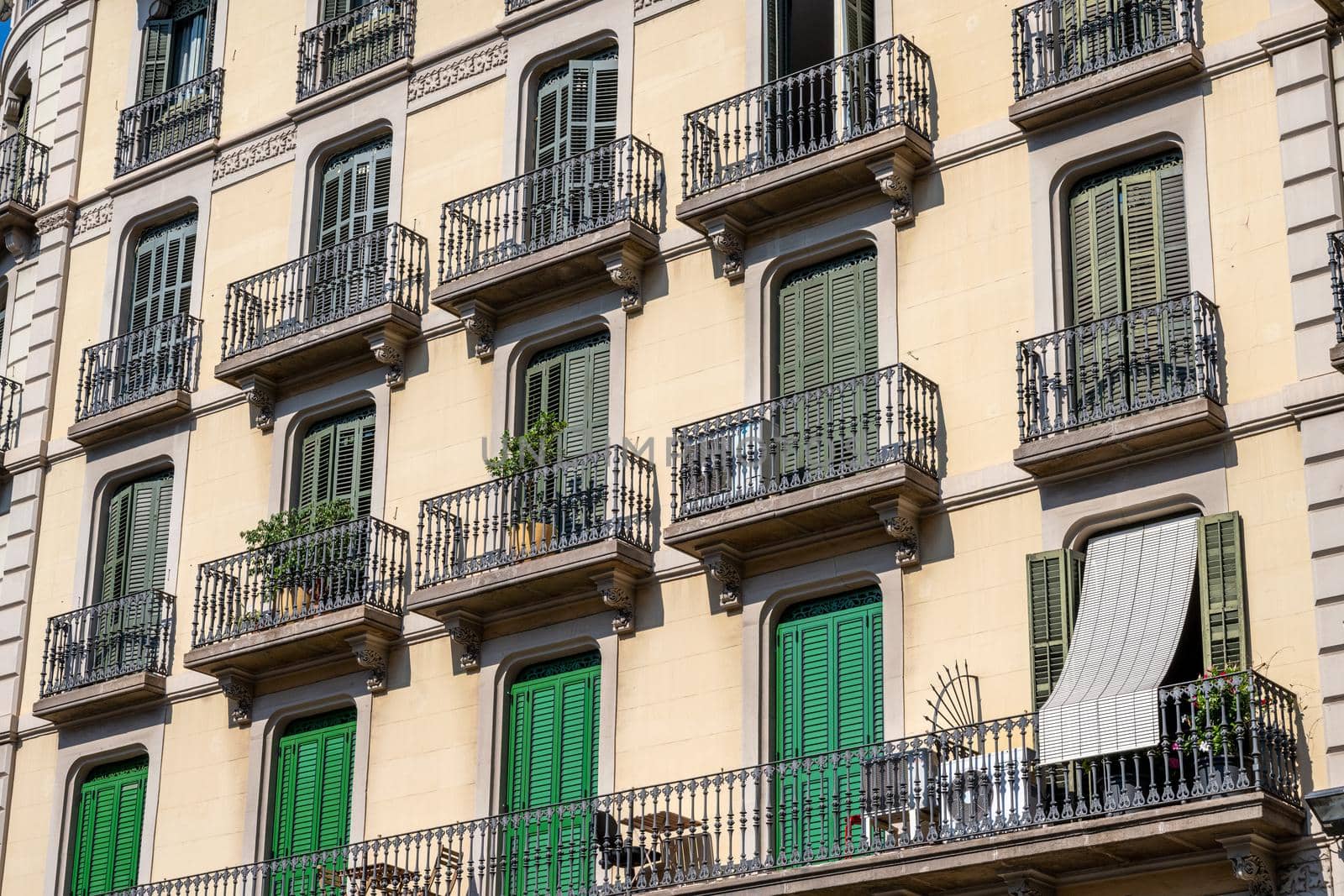 Typical house facade of an apartment building in Barcelona, Spain