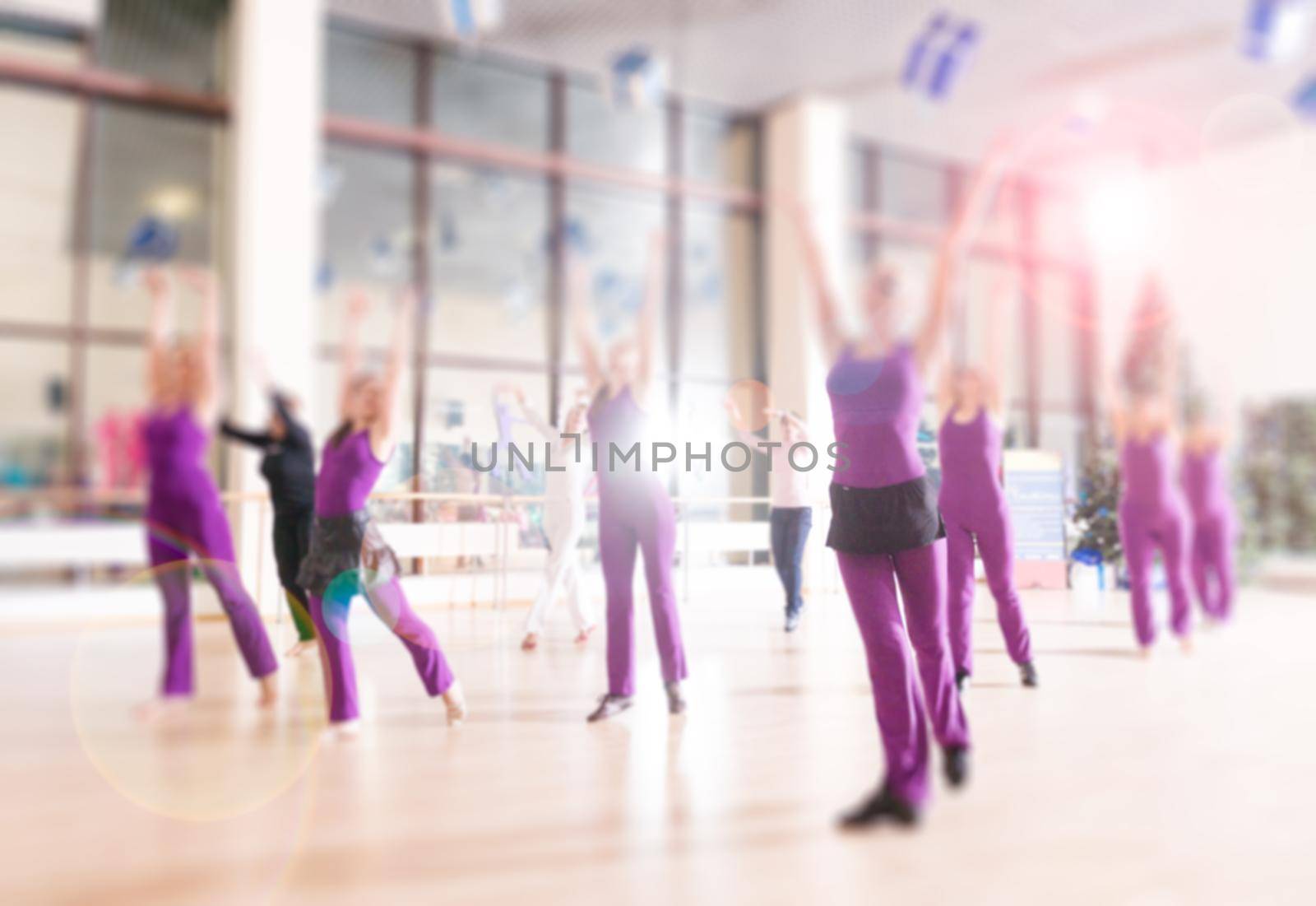 Dance class for women at fitness centre blur background