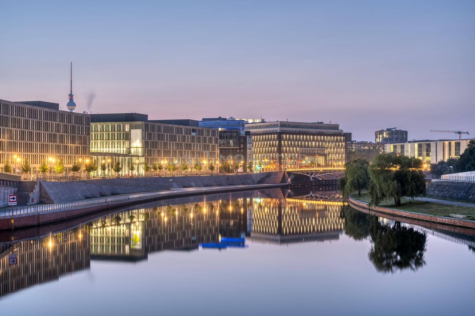 Modern office buildings at the river Spree in Berlin at dawn with the famous TV Tower in the back