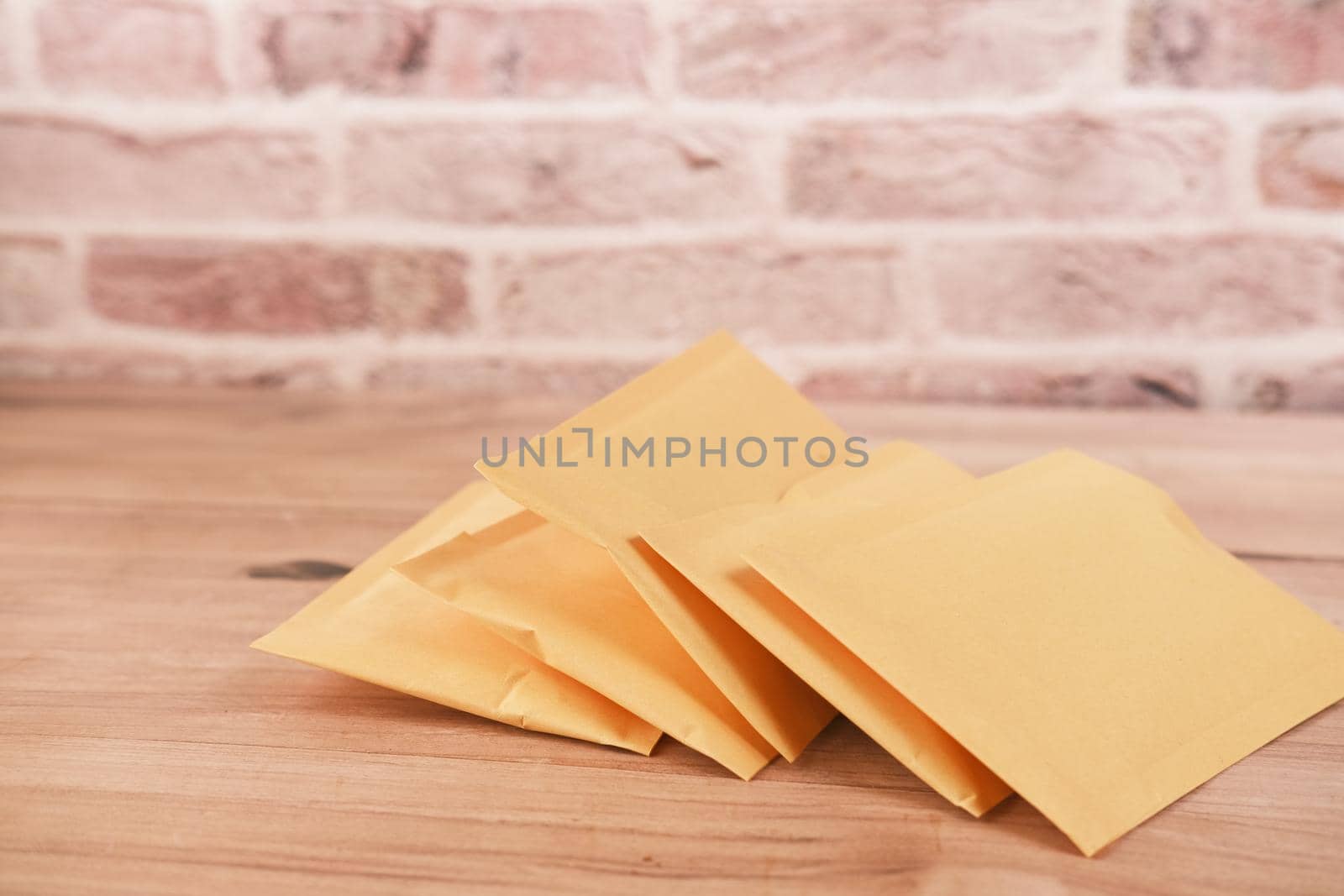 yellow paper bubble envelope on table by towfiq007