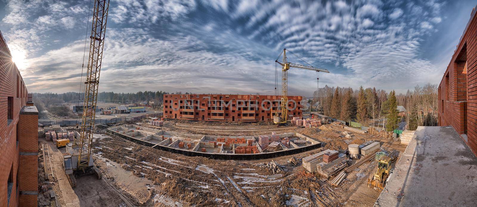 Big construction site with cranes in winter panorama