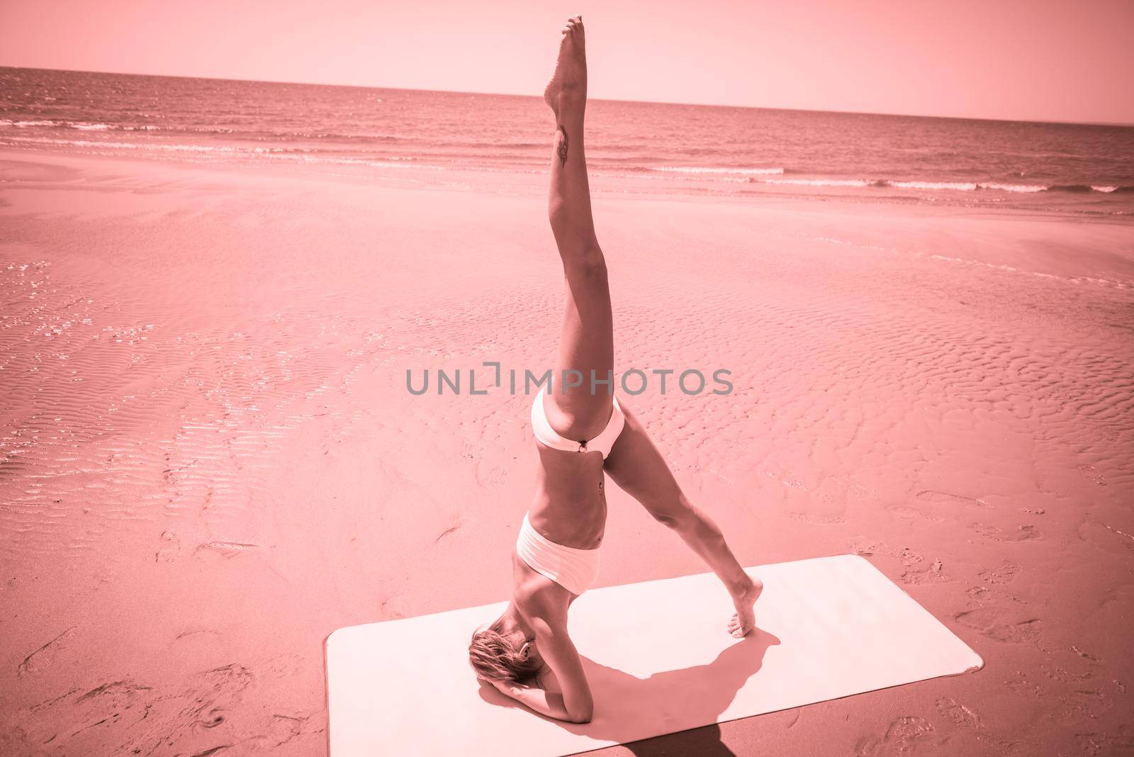 Woman doing yoga asana at the beach