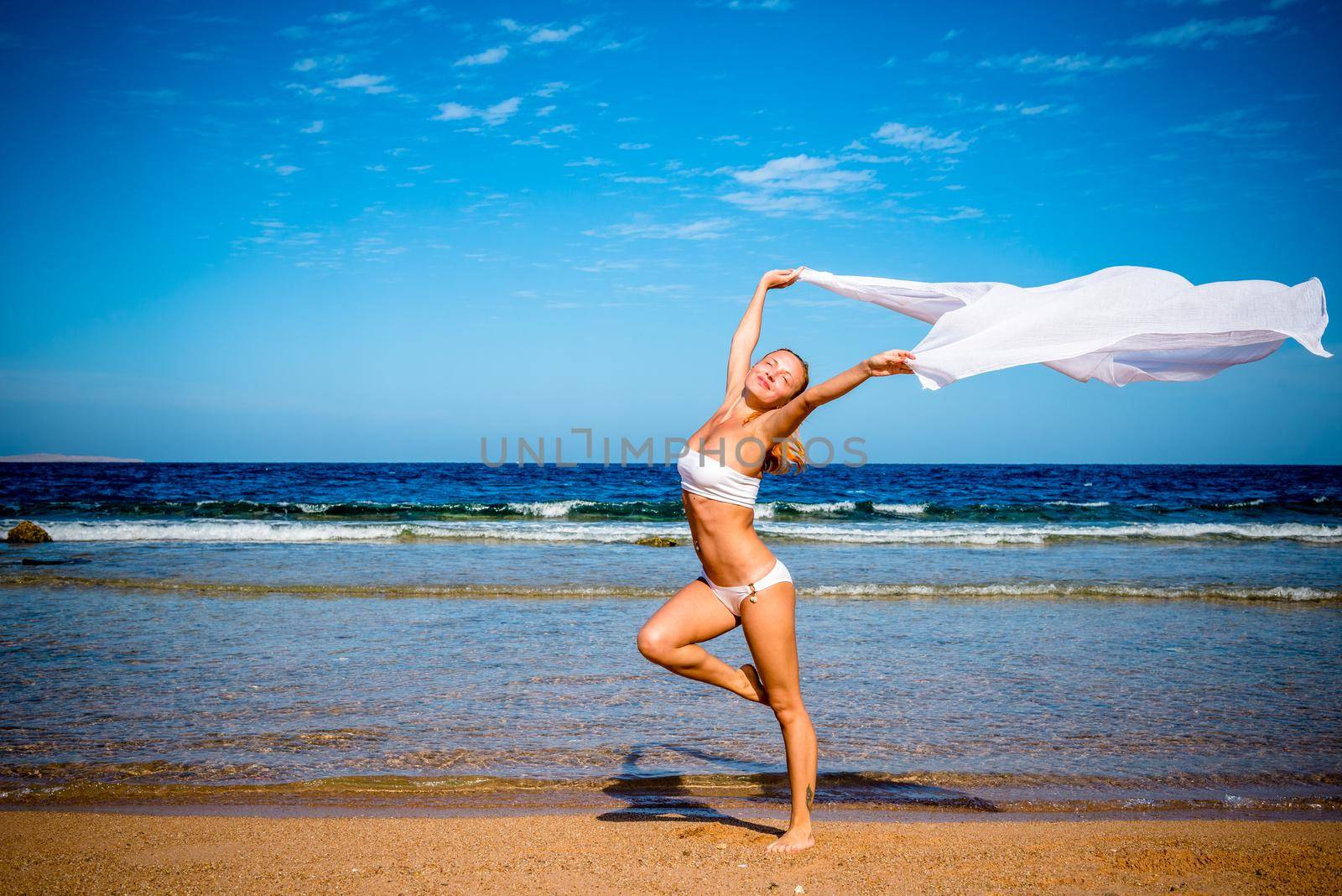 Carefree happy girl on the beach, fit sporty healthy sexy body in bikini