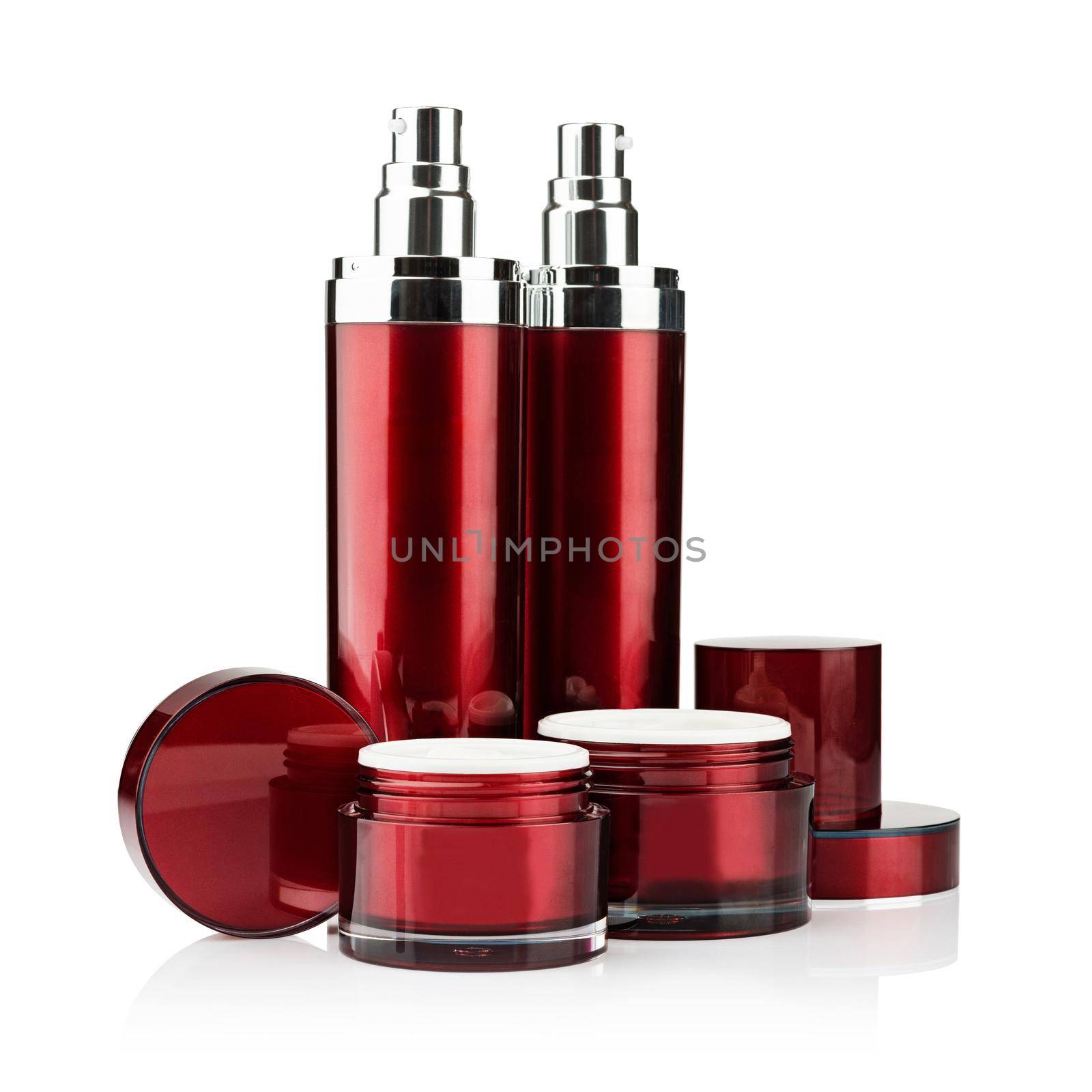 Red cosmetic cans of moisturizer isolated on white