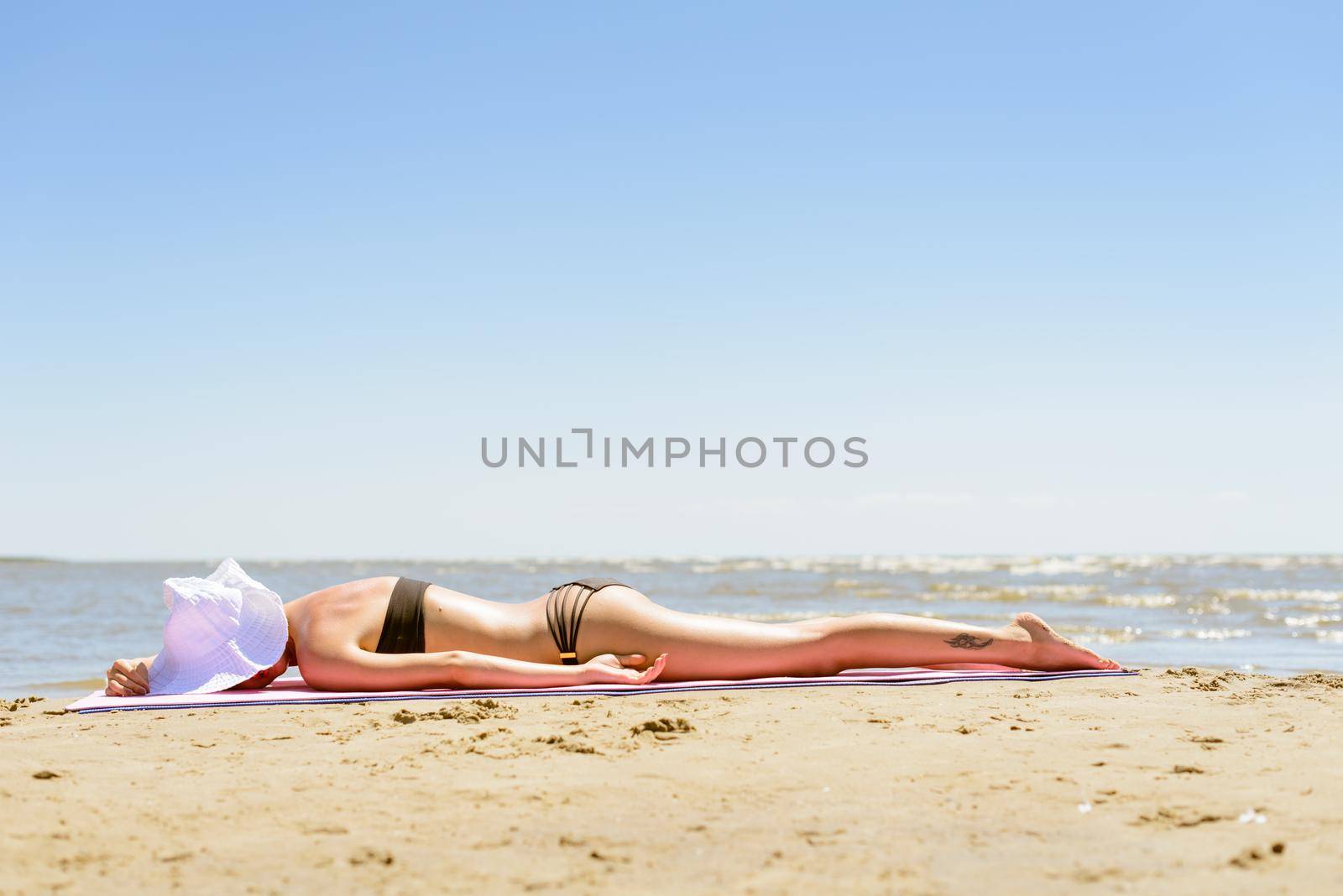 Girl in bikini on a beach by nikitabuida
