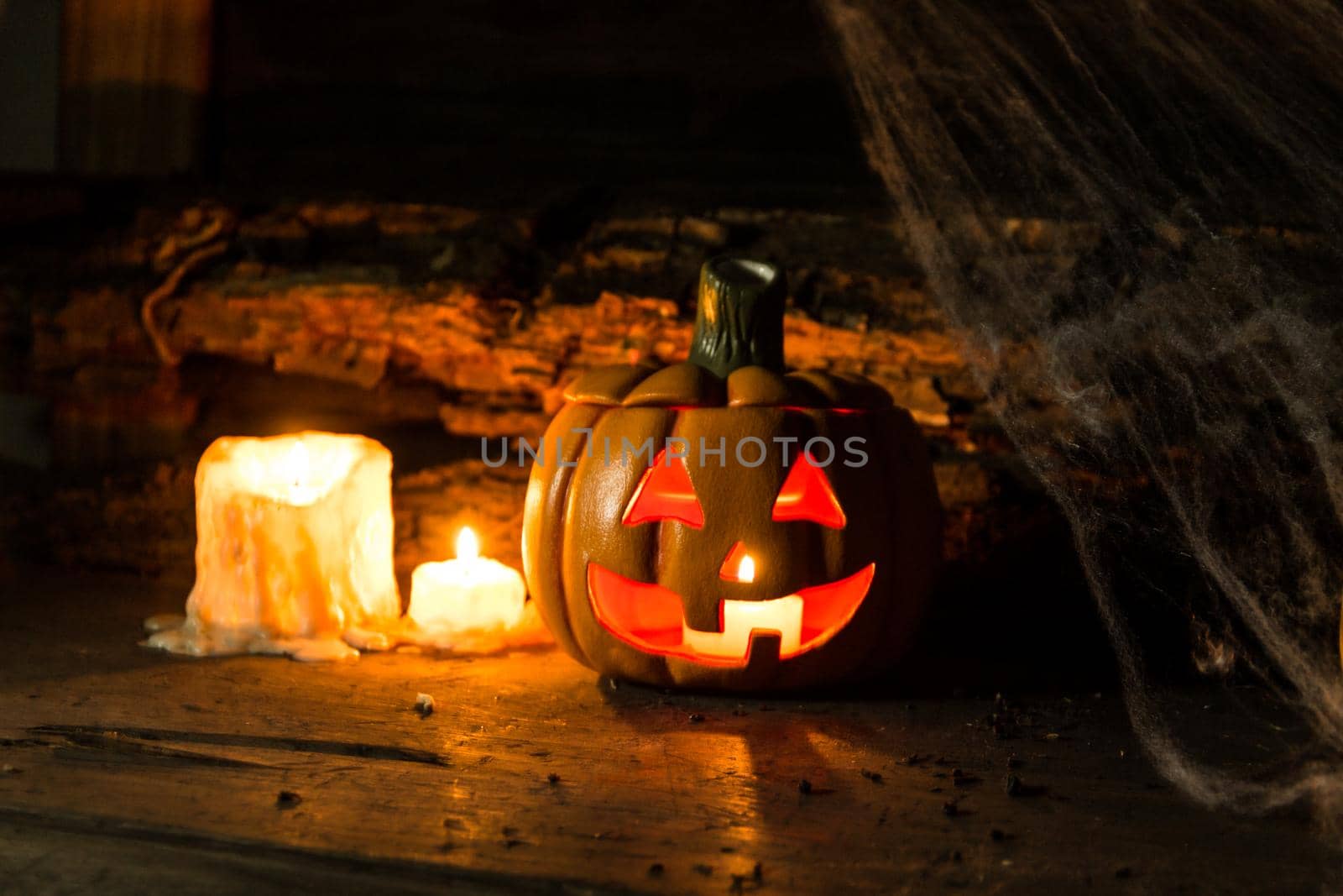 decoration for the hallowen celebration with pumpkins, spiders, candles on rustic wood