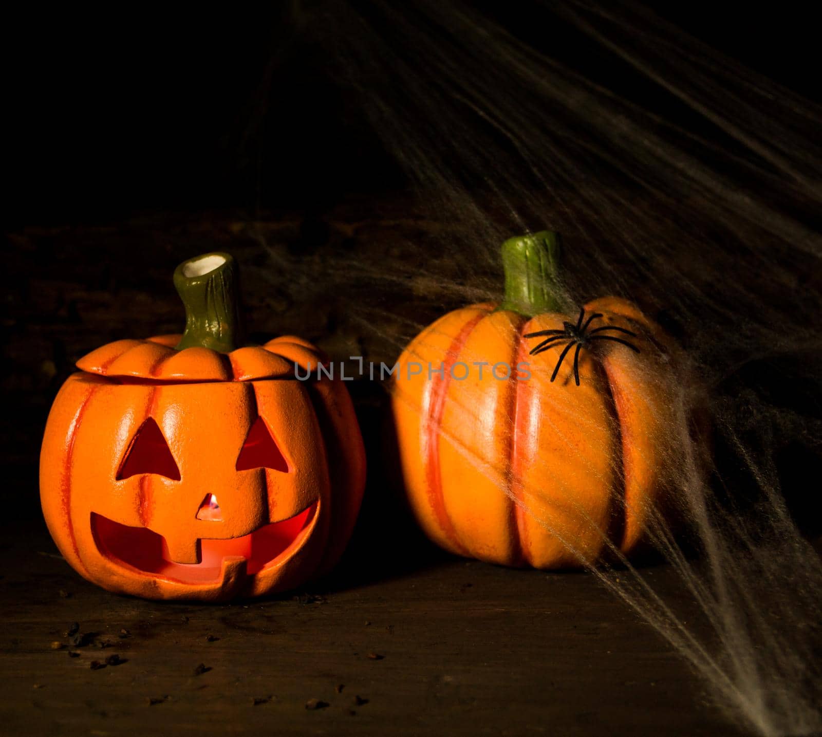 decoration for the hallowen celebration with pumpkins, spiders, candles on rustic wood