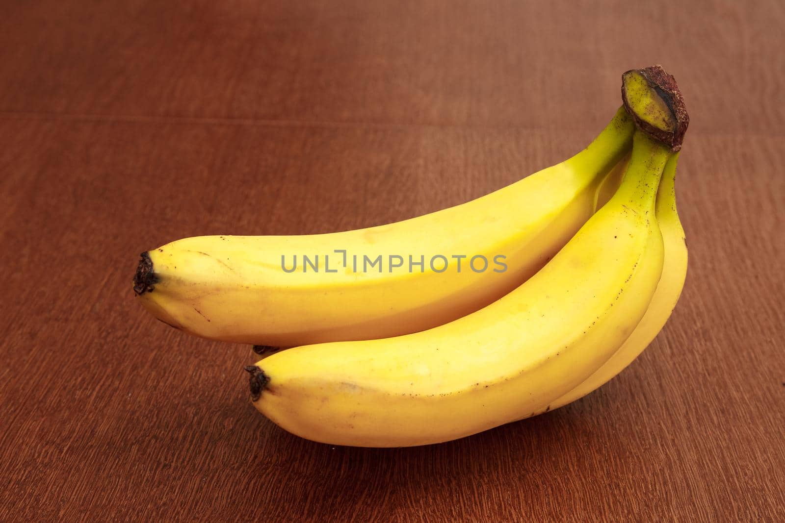 three ripe yellow bananas by raddnatt