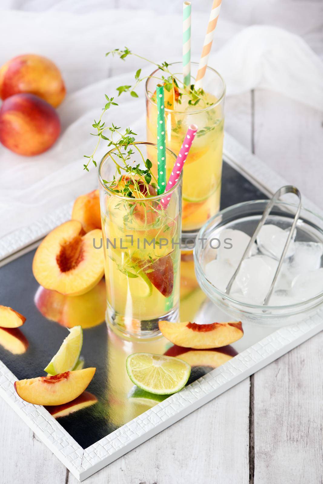 Peach summer cocktail. Refreshing organic non-alcoholic drink, lemonade with ripe nectarine, thyme and lime  