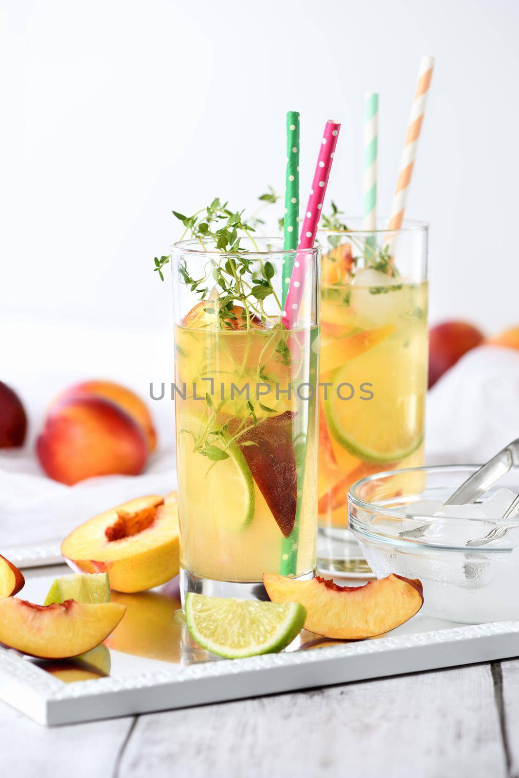 Peach summer cocktail. Refreshing organic non-alcoholic drink, lemonade with ripe nectarine, thyme and lime  