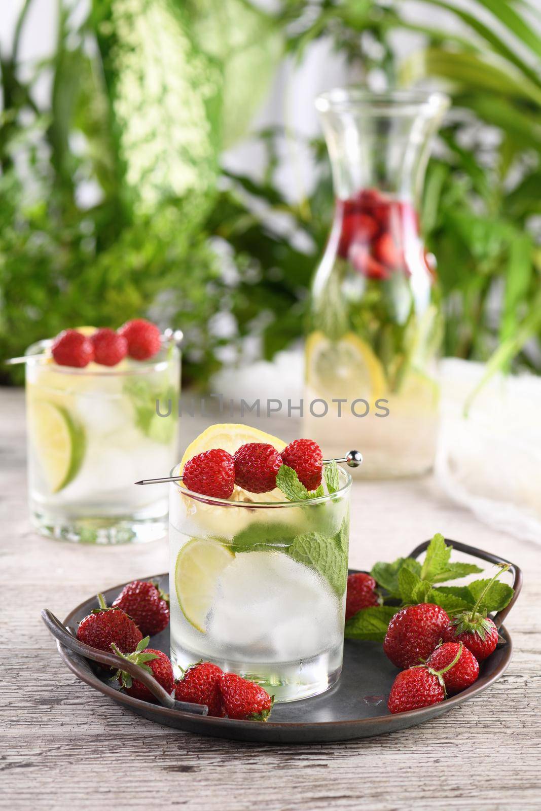 Refreshing organic Mojito cocktail with fresh lime, white rum combined with fresh strawberry and mint. This is the perfect cocktail for summer days.