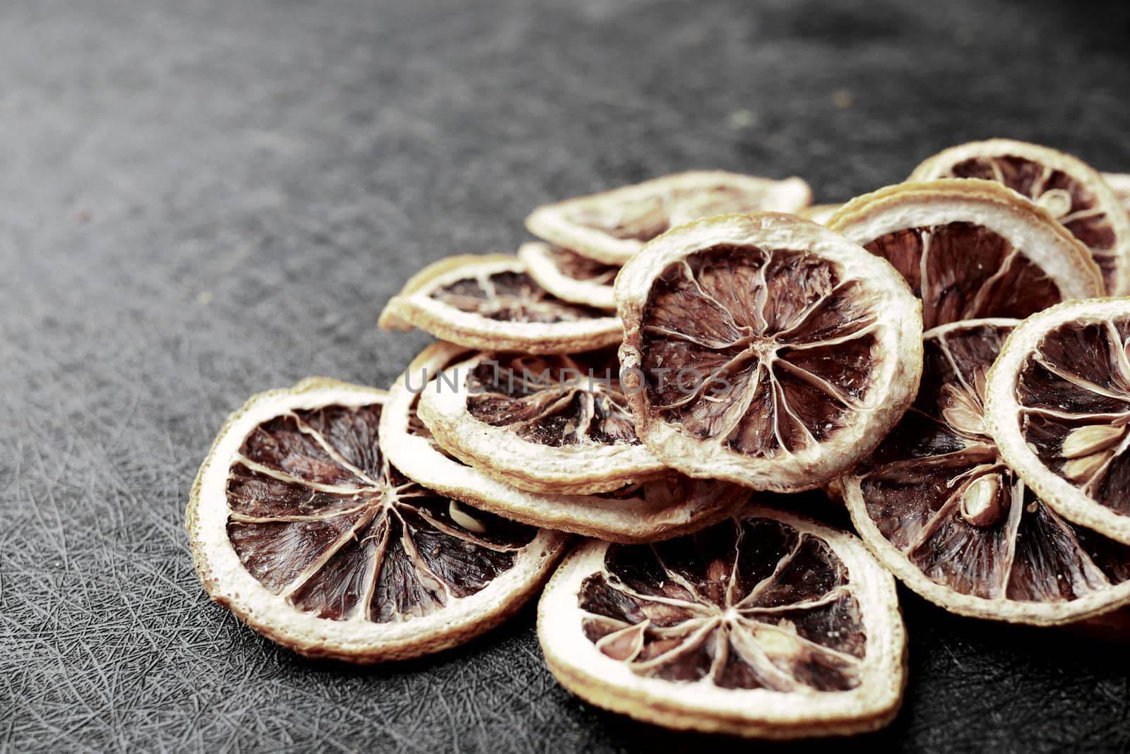 Pattern of dried raw orange on black background