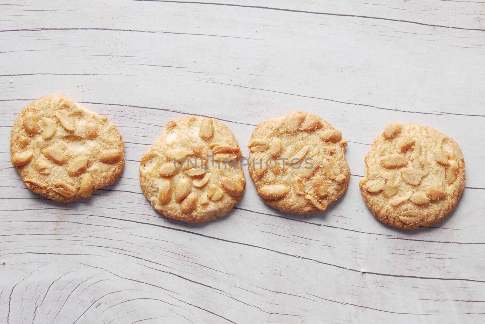 close up of peanut cookies on wooden table .