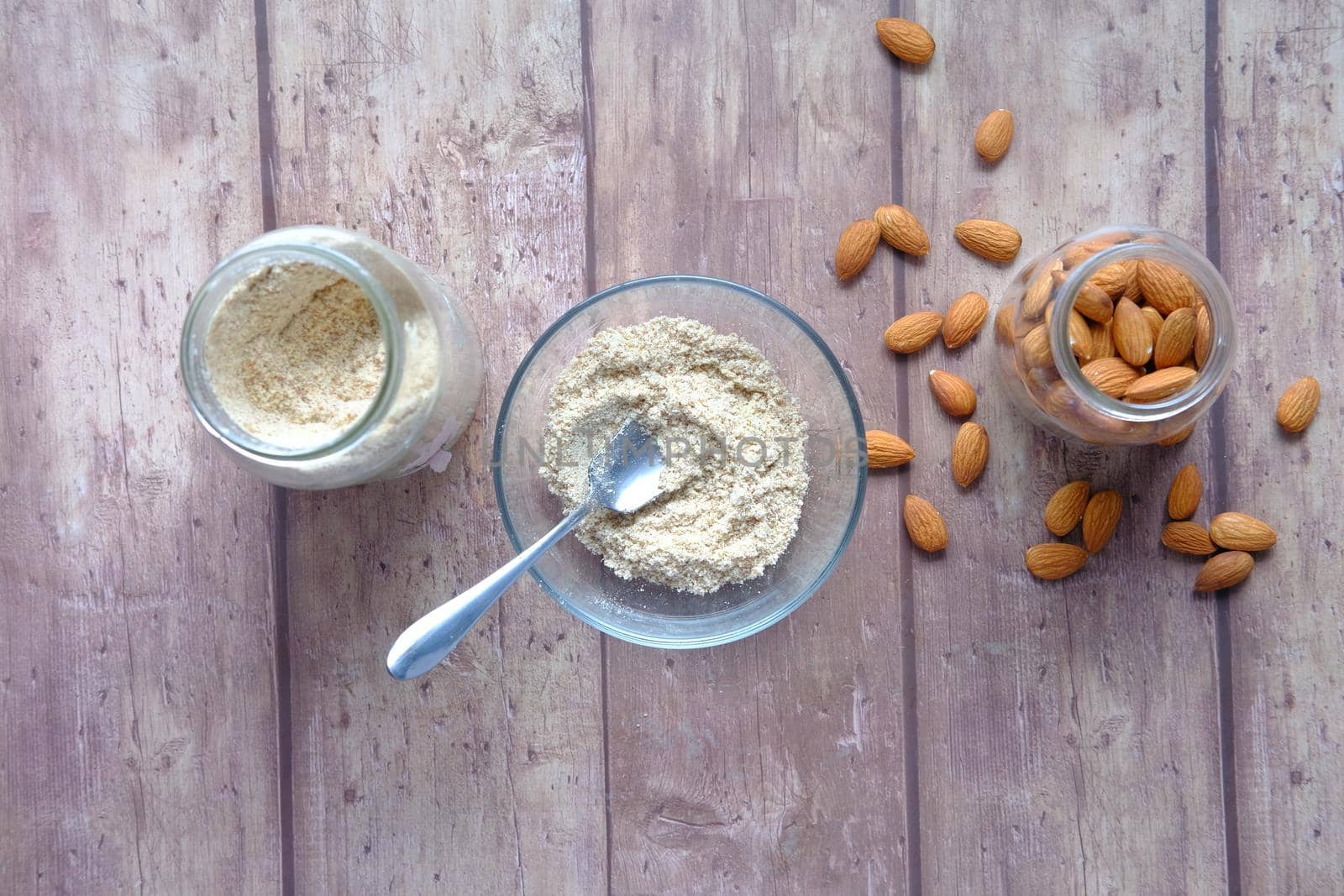 almond powder and almond in a jar on table, by towfiq007