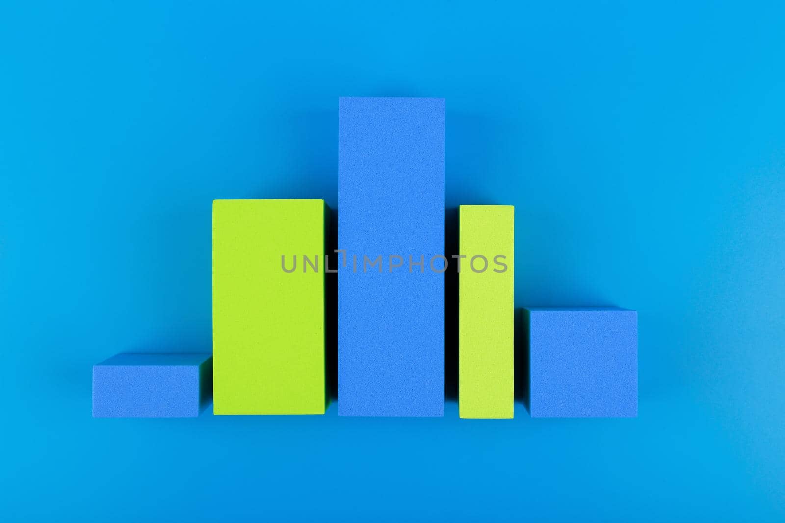 Business graph diagram or performance chart with blue and green bars with rise and fall dynamic against blue background by Senorina_Irina
