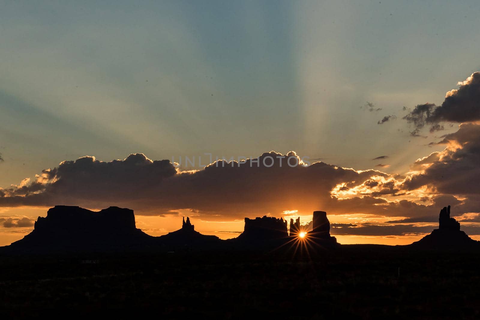 Artistic Utah Monument Valley mesa silhouette panorama at sunset with holy light heavenly godly spiritual
