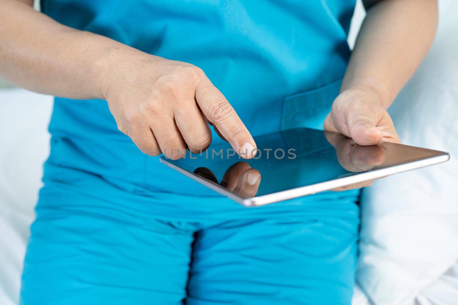 Doctor holding digital tablet to search data for treat patient in nursing hospital ward : healthy strong medical concept.