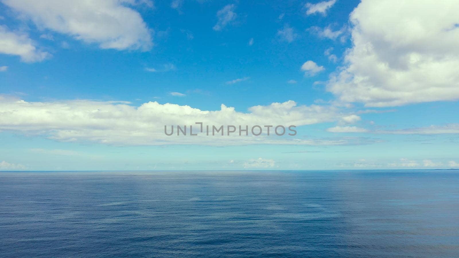 Seascape by day. Sea and sky with clouds in calm weather.