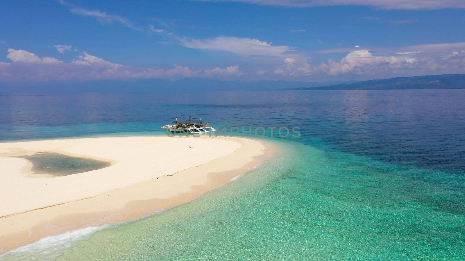 Tranquil beach scenery. Exotic tropical beach landscape with white sand beach and amazing turquoise sea. Digyo Island, Philippines.